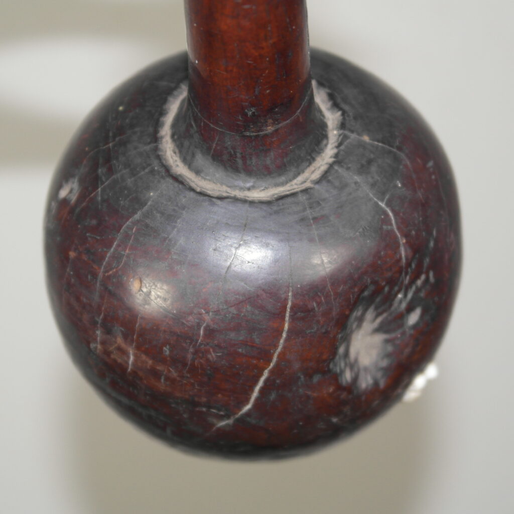Early 19th century Fijian ula throwing club with a single human tooth inset and tavatava carving to the handle. This club has three suspension holes to the handle all of which have broken through.